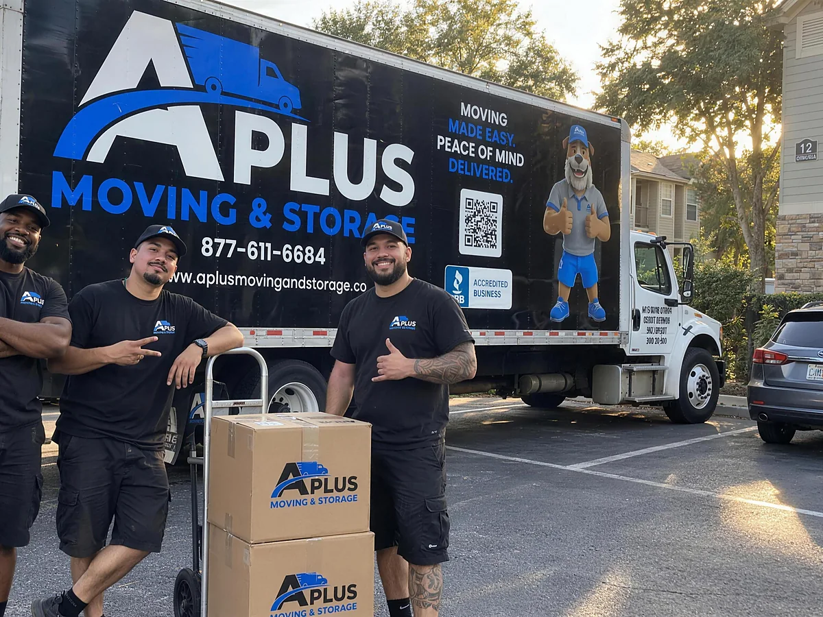 A Plus Moving & Storage crew with branded boxes in front of an A Plus truck