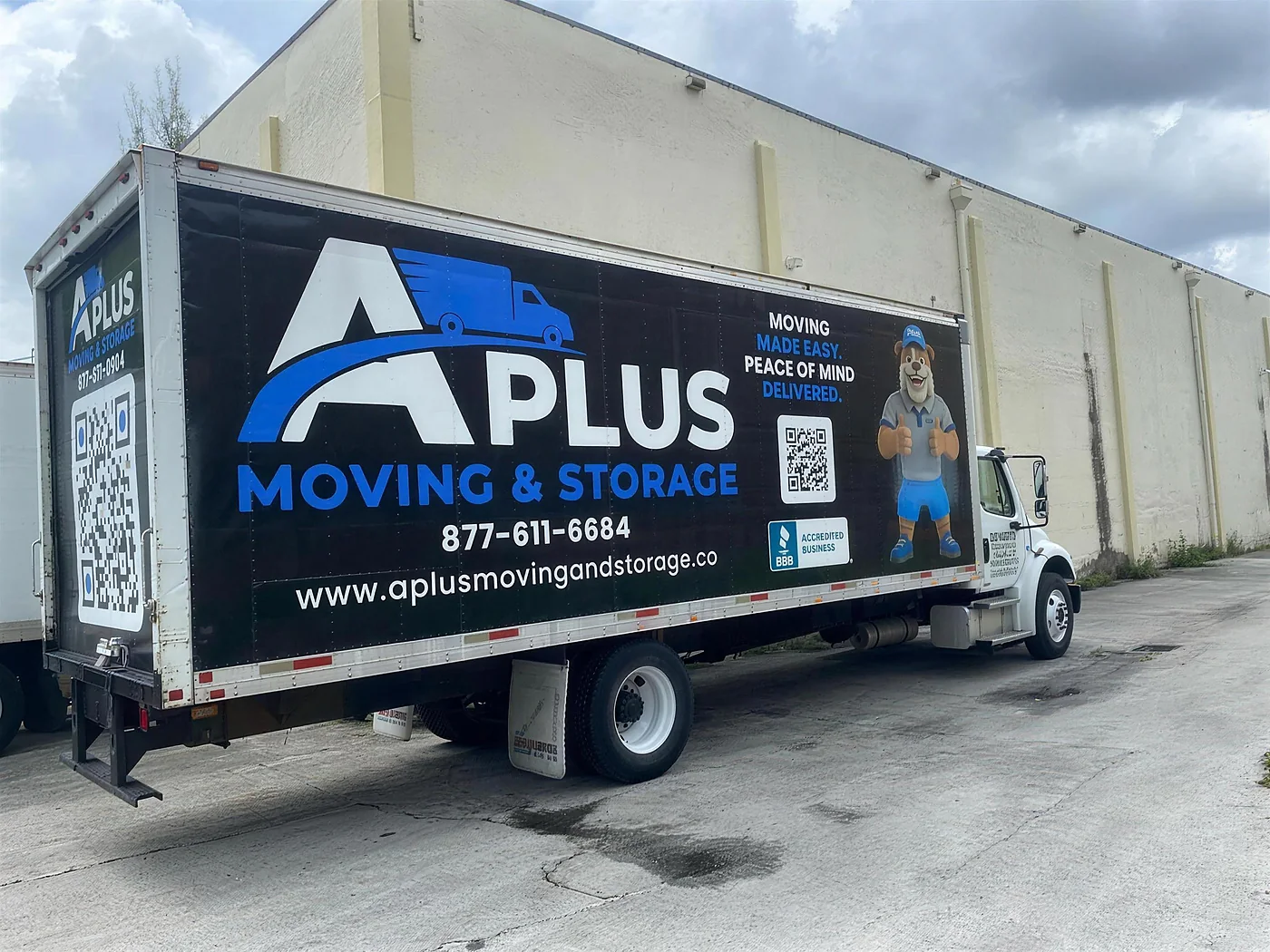A Plus Moving & Storage box truck, side view